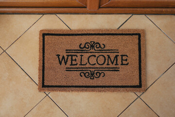 Door mat with word Welcome on floor, above view