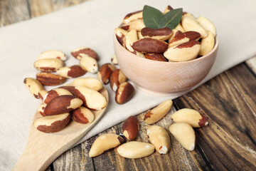 Many delicious Brazil nuts on wooden table