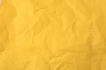 Sheet of crumpled orange paper as background, top view