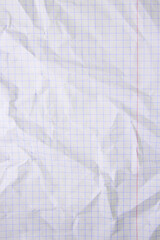 Sheet of crumpled checkered paper as background, top view