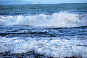Fototapeta premium Blue sea marine ocean seascape tropical huge wave on blurred background. Seascape blue ocean white wave motion outdoor. Aqua marine huge wave sea summer background. Paradise turquoise water landscape