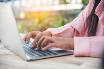 Woman typing laptop computer online meeting at home office work from home. Asian business woman using notebook laptop lifestyle. Happy programmer woman typing keyboard laptop read online website