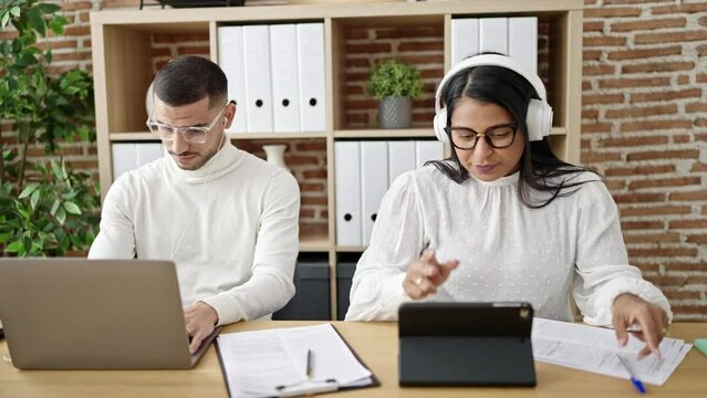 Man and woman business workers working together high five at office