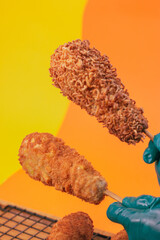 hand holding a corn dog