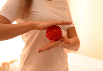 massage therapist holds back massage tools