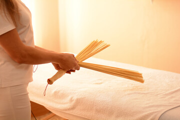 massage therapist holds back massage tools