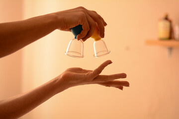 massage therapist holds back massage tools