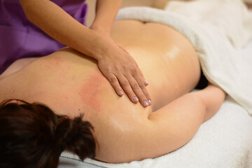 Fototapeta na wymiar a massage therapist gives a massage to a woman