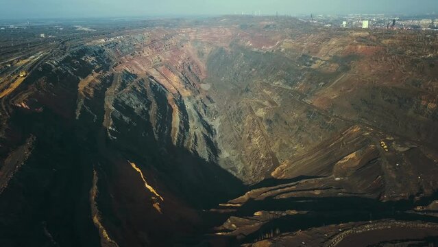 Panorama aerial view shot open pit mine coal mining, dumpers, quarrying extractive industry stripping work. Big Yellow Mining Trucks. View from drone at opencast mining with lots of machinery trucks