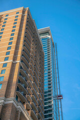 Fototapeta na wymiar Apartments or condominiums with blue sky backdrop in Austin Texas. The urban city skyline with residential buildings with balconies at a housing area.