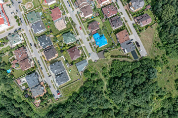 aerial top view of typical european housing estate near green park on sunny summer day