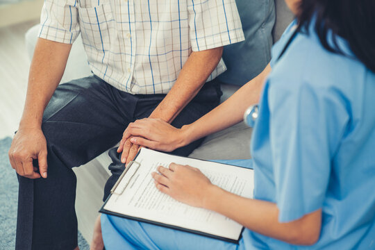 Senior man feeling contented as his caregiver provides him with good news about his health at medical consultation.