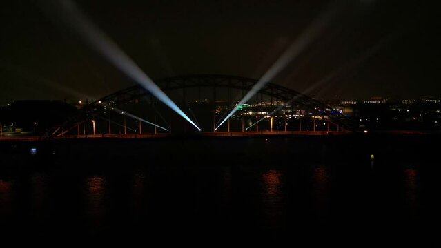 Night View With Lights Show On A Steel Suspension Bridge Over River Noord At Hendrik-Ido-Ambacht In The Netherlands. - Wide Shot