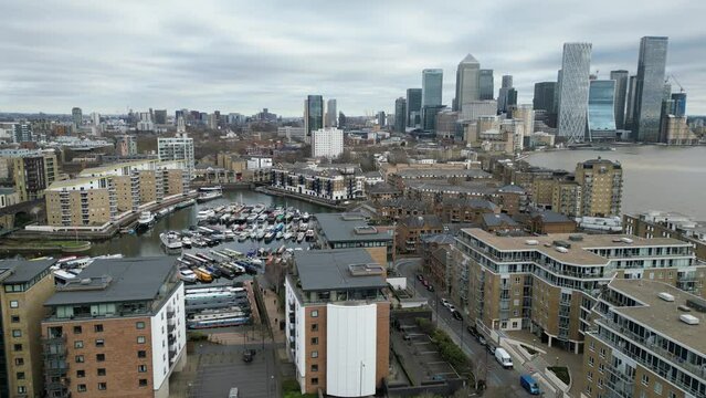 Panning drone aerial Limehouse basin London UK Canary Wharf in background