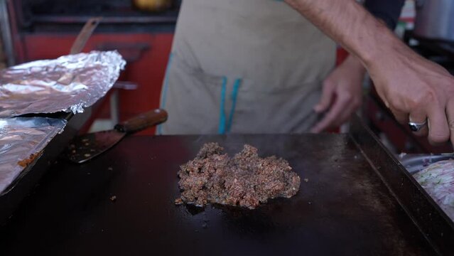 Street food making meat and onions with hands