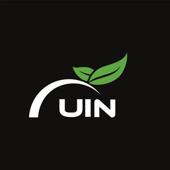Fototapeta premium UIN letter nature logo design on black background. UIN creative initials letter leaf logo concept. UIN letter design.