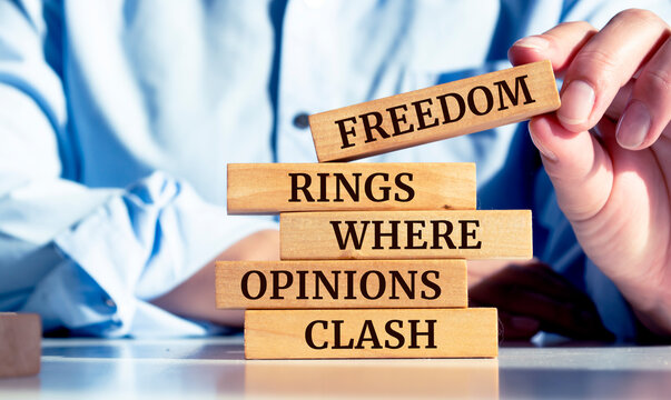 Wooden blocks with words 'Freedom rings where opinions clash'.
