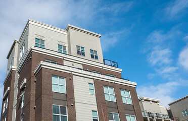 Fototapeta premium Modern apartment buildings on a sunny day with a blue sky. Facade of a modern apartment building. New apartment building
