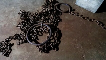 Chains on the floor in an african slave chamber of the Old Slave Market in Zanzibar. Human trafficking abolition