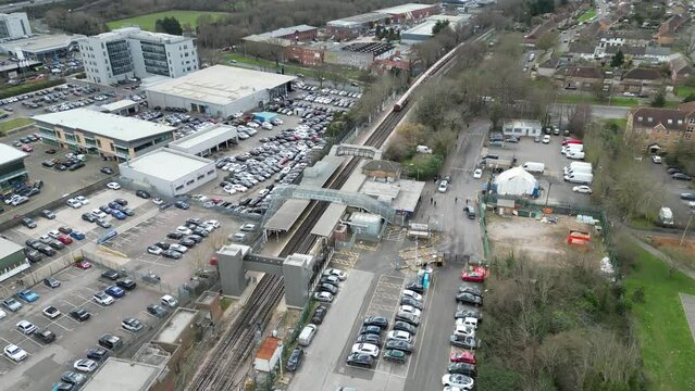 Train leaving Debden Central line station Essex UK drone aerial view