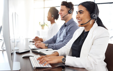 Woman, call center and computer typing and consulting in telemarketing, customer service or support at office. Happy female consultant talking on mic sitting by desktop PC in contact us for sales