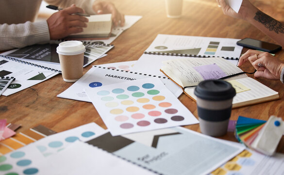 Creative, hands and color palette on table for planning, meeting or brainstorming in design strategy at office. Hand of group interior designers in teamwork, project plan or swatch ideas for startup