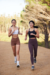Fitness women or friends running in nature, forest or park for workout, exercise and cardio training together. Diversity athlete, sports or runner people outdoor jogging for body health and wellness