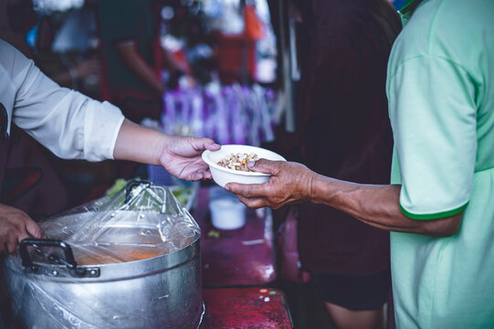 Volunteers distribute free food to the poor : charity food ideas