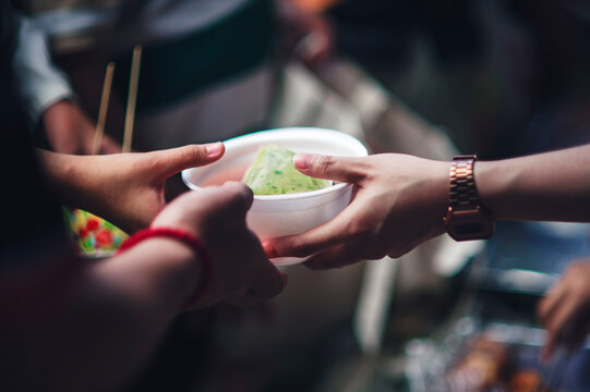 Volunteers distribute free food to the poor : charity food ideas