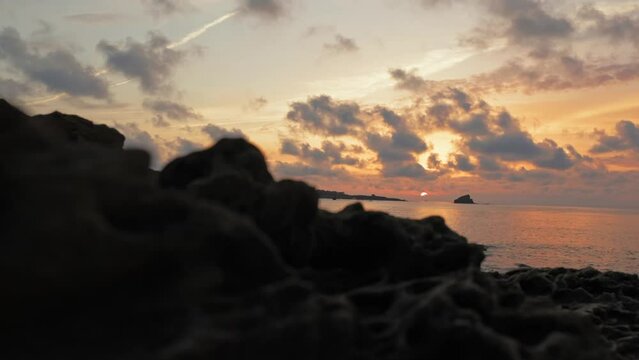 Beautiful sunset on coast of Cadaques with rocks on beach, Spain