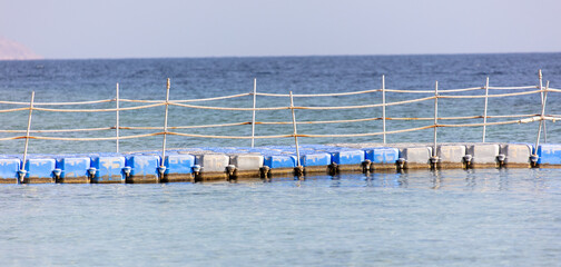 Pontoon bridge on the blue water of the sea.