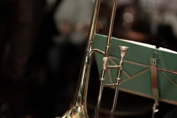 Fototapeta na wymiar A trombone in front of a music stand with sheet music