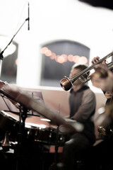Fototapeta premium A trumpet player of a big band playing a solo on his trumpet using a harmon or bubble mute