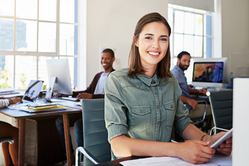 Portrait of woman in creative agency with smile, staff and tablet, success at design startup. Happy designer in modern office, manager or team leader working at laptop at desk with digital technology