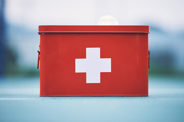 First aid, box and medical equipment for health emergency, response and treatment kit isolated in a...