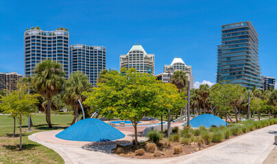 Regatta Park in Miami Beach Florida against apartments and sky on a sunny day. Public recreation area in the city with walkways and trees for visitors and tourists.