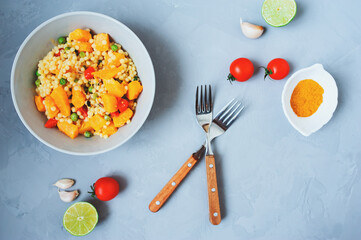 homemade ptitim pasta cooked in arabian style with curry, pumpkin and fresh cerry tomatoes