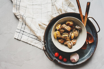 Raw Shells Clams vongole on plate. Ingredients for cooking seafood pasta. Meditterian cuisine.