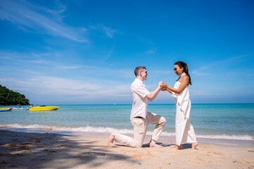 happy couple jumping on the beach romantic moments in honeymoon trip.