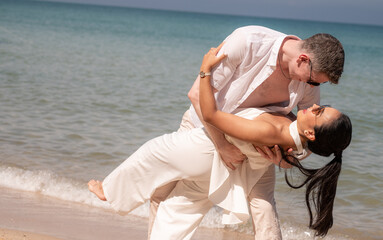 happy couple jumping on the beach romantic moments in honeymoon trip.