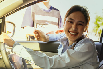 Businesswoman drives car to contact service in front of the security zone check the id card for...