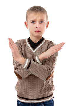 Nearly Crying Eight Year Old Boy Crossed Hand And Showing Refusal Gesture. Little Schoolboy Showing Stop Gesture, Way Prohibited. Cute Blond Kid Posing In Studio, Isolated On White Background..