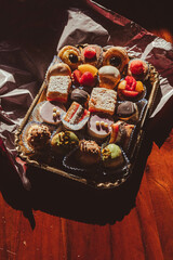Italian colorful pastry on a wooden table in bright sunlight 