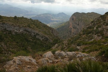 View of Montgó mountain in Spain with its cliffy, green surroundings overlooking the valley of Oliva.