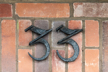 Metal number on brick wall