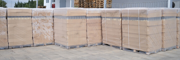 Rows of boxes and pallets in warehouse and production warehouse