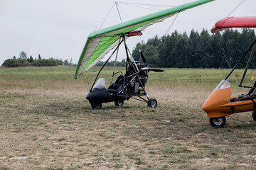 Powered hang glider at a field airport.