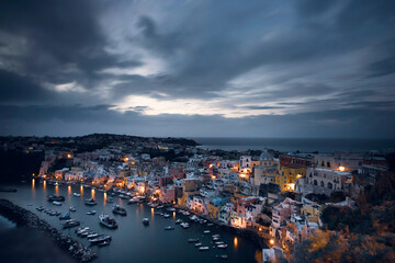 Beautiful fishing village at night, Marina Corricella on Procida Island, Bay of Naples, Italy.