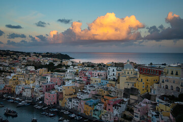 Beautiful fishing village in sunset, Marina Corricella on Procida Island, Bay of Naples, Italy.