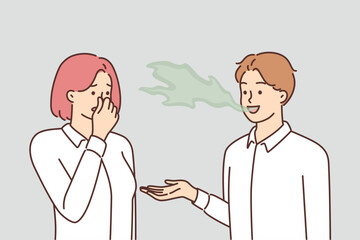 Woman covers nose with hand, feels discomfort communicating with man due to bad breath - obrazy, fototapety, plakaty